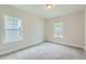 Bright bedroom features soft carpet and two windows offering natural light at 924 Jasper Mine Trl, Raleigh, NC 27610