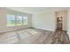 Spacious bedroom with large windows offering ample natural light and wood flooring at 924 Jasper Mine Trl, Raleigh, NC 27610