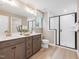 Bathroom with double vanity, glass shower, and wood look floor at 200 Faith Ave, Sanford, NC 27330