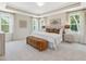 Bright main bedroom suite with a large bed, natural light, and tray ceiling at 200 Faith Ave, Sanford, NC 27330