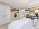 Neutral bedroom featuring a dresser, white bedding, and painted accent wall at 200 Faith Ave, Sanford, NC 27330