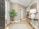 Bright entryway with wood floors, plant, console table, and view to living space at 200 Faith Ave, Sanford, NC 27330