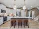 Modern kitchen with white cabinets, stainless steel appliances, and island seating at 200 Faith Ave, Sanford, NC 27330