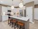Bright kitchen with a large island, white cabinets, and stainless steel appliances at 200 Faith Ave, Sanford, NC 27330