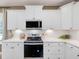 Modern kitchen featuring stainless steel appliances, white cabinets, and light countertops at 200 Faith Ave, Sanford, NC 27330