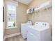 Well-lit laundry room with washer, dryer, shelves, and a window at 0 Faith Ave, Sanford, NC 27330