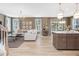 Open-concept living room and kitchen area with hardwood floors and natural lighting at 200 Faith Ave, Sanford, NC 27330