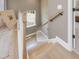 View from the second floor of the wood stairs with white banisters and a large window at 200 Faith Ave, Sanford, NC 27330