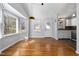 Bright dining area with hardwood floors, a modern light fixture and access to the kitchen at 101 Longneedle Ct, Raleigh, NC 27603