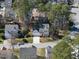 Aerial shot of a beautiful home nestled amongst lush trees in a quiet neighborhood at 102 Ashley Brook Ct, Cary, NC 27513