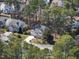 Aerial shot of a beautiful home nestled amongst lush trees in a quiet neighborhood at 102 Ashley Brook Ct, Cary, NC 27513