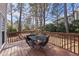 Outdoor deck features a small black table and chair set surrounded by trees at 102 Ashley Brook Ct, Cary, NC 27513