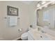 Powder room featuring neutral tones, a framed mirror, decorative art, and white fixtures at 102 Ashley Brook Ct, Cary, NC 27513