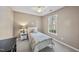 Neutral bedroom features a ceiling fan, natural light from a window, and a bed with side table at 102 Ashley Brook Ct, Cary, NC 27513