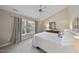 Bedroom featuring neutral tones, carpet, large windows and a decorative ceiling fan at 102 Ashley Brook Ct, Cary, NC 27513