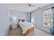 Light blue bedroom features 2 large windows, a bed, side table and accent lamp at 102 Ashley Brook Ct, Cary, NC 27513