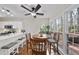 The breakfast nook features bright windows and a wooden table with seating, a ceiling fan, and an adjacent deck at 102 Ashley Brook Ct, Cary, NC 27513