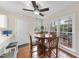 Bright breakfast nook with a wooden table, seating, a ceiling fan, and views of the wooden deck at 102 Ashley Brook Ct, Cary, NC 27513