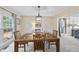 Bright dining room features a wooden table with seating for four under a pendant light fixture at 102 Ashley Brook Ct, Cary, NC 27513