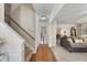 Open entryway featuring hardwood floors, a staircase, and views into the living room and backyard at 102 Ashley Brook Ct, Cary, NC 27513
