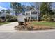 Two-story home boasts a manicured lawn, mature trees, and a two-car attached garage at 102 Ashley Brook Ct, Cary, NC 27513