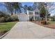 Traditional two-story home with green shutters, lush landscaping, and a two-car attached garage at 102 Ashley Brook Ct, Cary, NC 27513