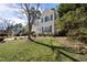 A charming two-story home with light yellow siding, green shutters, and a well-manicured lawn on a sunny day at 102 Ashley Brook Ct, Cary, NC 27513