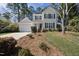 Charming two-story home with light yellow siding, green shutters, a front yard, and an attached one-car garage at 102 Ashley Brook Ct, Cary, NC 27513
