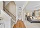 Inviting hallway with hardwood floors leads into a cozy living room and dining area with natural light at 102 Ashley Brook Ct, Cary, NC 27513
