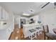 Bright kitchen with white cabinets, stainless steel appliances, hardwood floors, and a breakfast bar with seating at 102 Ashley Brook Ct, Cary, NC 27513