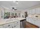 Bright kitchen featuring white cabinetry, stainless appliances, laminate countertops, and a view into the breakfast nook at 102 Ashley Brook Ct, Cary, NC 27513