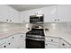 Bright kitchen with white cabinetry, stainless appliances, and laminate countertops at 102 Ashley Brook Ct, Cary, NC 27513