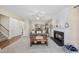 Inviting living room with a cozy fireplace, ceiling fan, large windows, and comfortable seating for relaxing at 102 Ashley Brook Ct, Cary, NC 27513