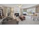 Inviting living room with a cozy fireplace, ceiling fan, large windows, and comfortable seating for relaxing at 102 Ashley Brook Ct, Cary, NC 27513