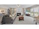 Inviting living room with a cozy fireplace, ceiling fan, large windows, and comfortable seating for relaxing at 102 Ashley Brook Ct, Cary, NC 27513