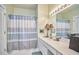 Bright bathroom featuring striped shower curtain and vanity with modern lighting at 102 Westside Dr, Chapel Hill, NC 27516