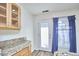 Bright kitchen with granite counters, wood cabinets and an exterior door to the outdoors at 103 White Oak Way, Chapel Hill, NC 27514