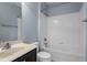 This bathroom features a shower over the tub, a vanity sink with solid surface countertop, and painted walls at 10321 Sablewood Dr # 108, Raleigh, NC 27617