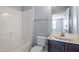 Bathroom features shower over tub, vanity sink with solid surface countertop, and updated fixtures at 10321 Sablewood Dr # 108, Raleigh, NC 27617
