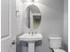 Powder room features pedestal sink, elongated toilet, and neutral paint with updated chrome fixtures at 10321 Sablewood Dr # 108, Raleigh, NC 27617