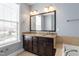 Bathroom with double vanity sinks, granite countertops, and a large framed mirror at 10321 Sablewood Dr # 108, Raleigh, NC 27617