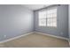 Bedroom with neutral carpeting and a window with white blinds to control the sunlight at 10321 Sablewood Dr # 108, Raleigh, NC 27617