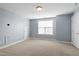 Carpeted bedroom features neutral walls, a flush mount light fixture, a window, and white doors and trim at 10321 Sablewood Dr # 108, Raleigh, NC 27617