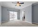 Bright bedroom featuring a ceiling fan, light blue walls, carpet, and a door to an outside deck at 10321 Sablewood Dr # 108, Raleigh, NC 27617
