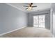 Spacious bedroom featuring a ceiling fan and sliding glass doors to the outside at 10321 Sablewood Dr # 108, Raleigh, NC 27617