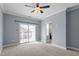 Spacious bedroom with a ceiling fan and a doorway leading to the attached bathroom at 10321 Sablewood Dr # 108, Raleigh, NC 27617