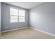 Bedroom with neutral carpet, a window, and a light blue painted wall at 10321 Sablewood Dr # 108, Raleigh, NC 27617