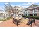 Outdoor fireplace with stone surround and multiple seating options at 10321 Sablewood Dr # 108, Raleigh, NC 27617