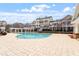 Resort-style community pool with lounging area, pergolas, and neighboring townhomes at 10321 Sablewood Dr # 108, Raleigh, NC 27617