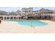Community pool with resort-style lounge area and neighboring townhomes at 10321 Sablewood Dr # 108, Raleigh, NC 27617